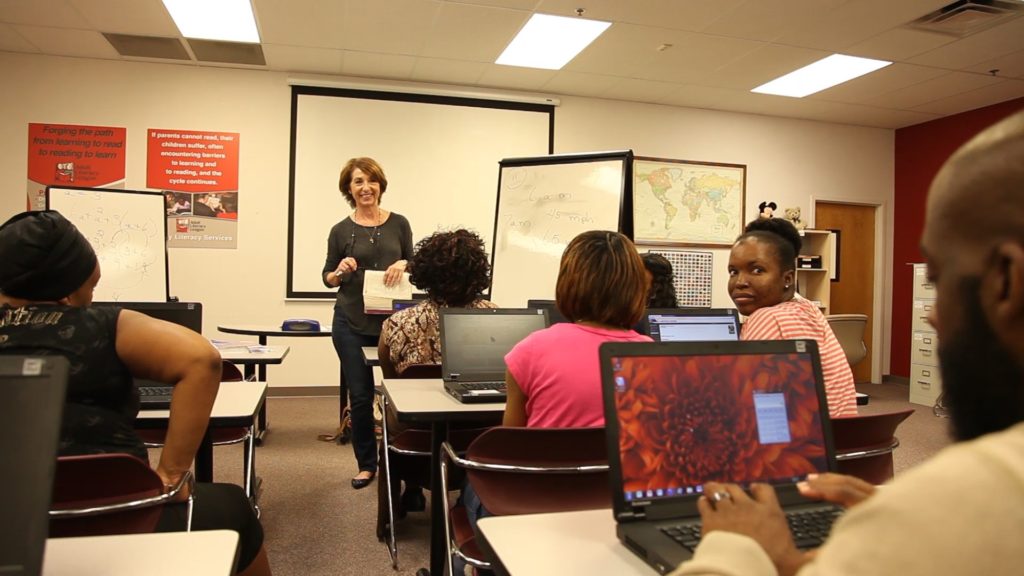 Francesca Mathews, one of the Adult Literacy League’s long-time tutors, teaches adult students in the new GED lab.