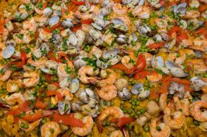 Authentic Spanish paella with shrimp, clams, chicken, scallops and yellow rice