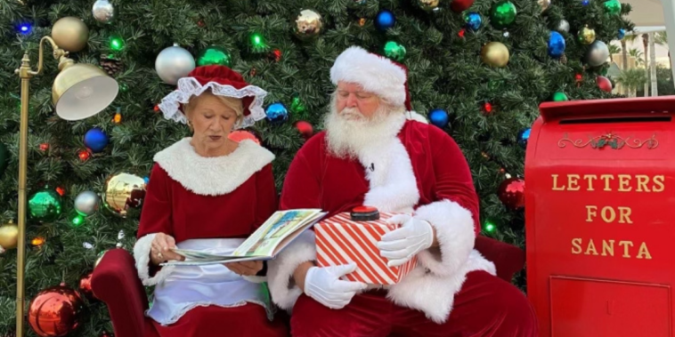 Mike and Debbie Crews dressed as Mr. and Mrs. Claus reading T'was the Night Before Christmas at Devereux's Viera, Florida campus