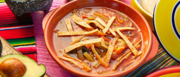 Photo of a bowl of tomato soup along with recipe for bean soup.