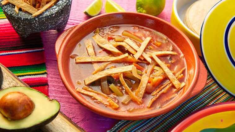 Photo of a bowl of tomato soup along with recipe for bean soup.