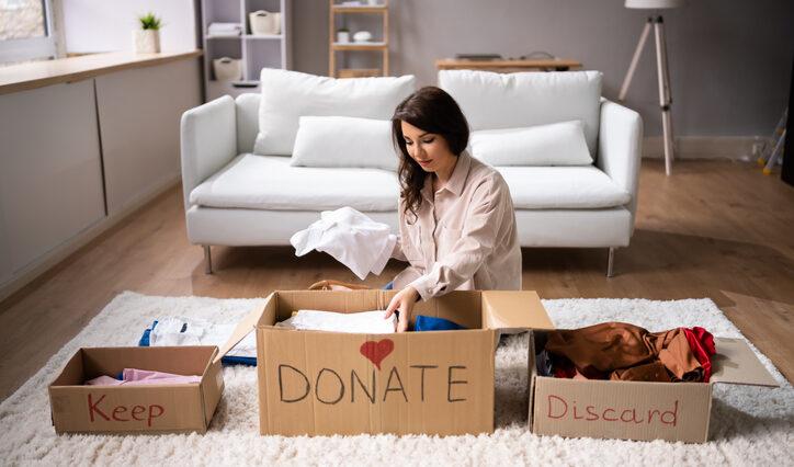 Woman Donating and practicing Decluttering tips And Cleaning Up Wardrobe Clothes