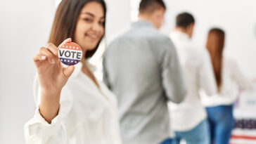 woman showing her vote sticker