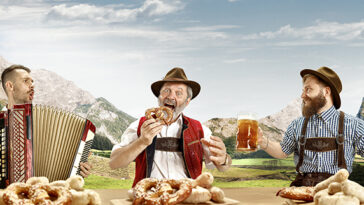 men dressed in costumes drinking beer Oktoberfest