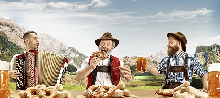 men dressed in costumes drinking beer Oktoberfest