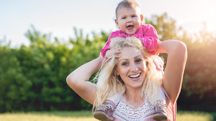 young mom holding her child on her neck