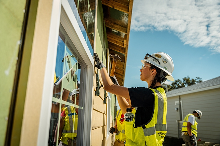 a Habitat for Humanity team working together to build a home.