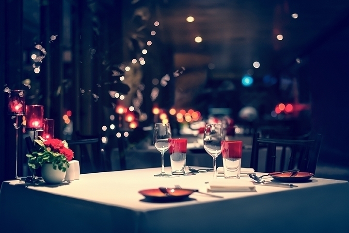 dinner setup, red decoration with candle light in a restaurant. Christmas decoration setting