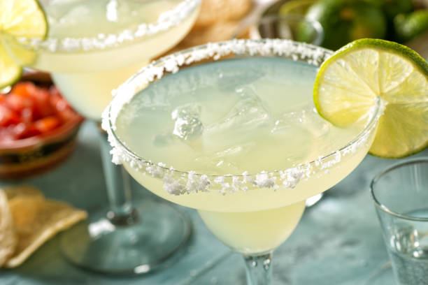 Delicious tequila and lime margaritas on an outdoor table with tortilla chips