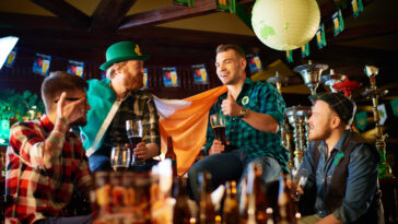 friends enjoying a beer while celebrating St.Patrick's Day