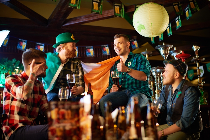 friends enjoying a beer while celebrating St.Patrick's Day