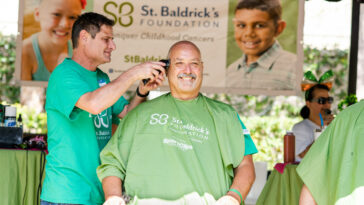 man getting head shaved at event for charities