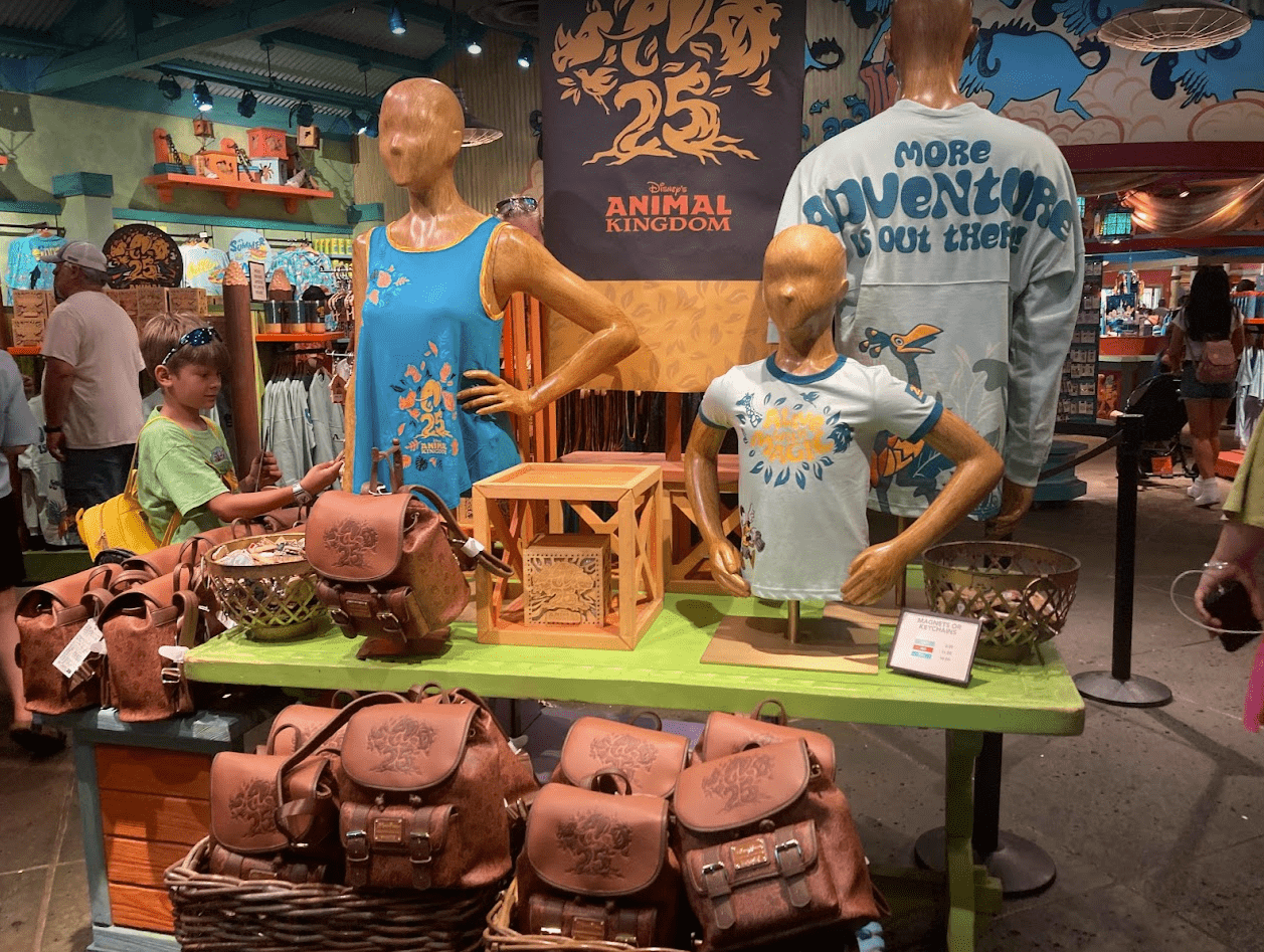 Disney's Animal Kingdom 25th Anniversary merch shirts bags green table gift shop