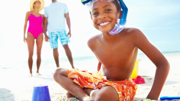 A child and his family at the beach.