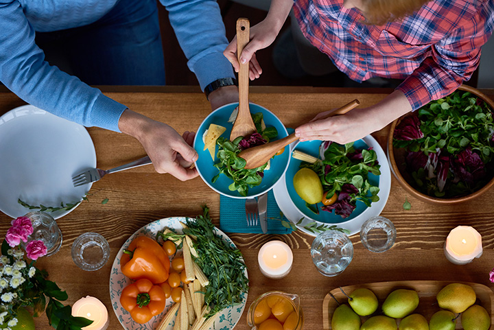 Friends passing around food to create meals.