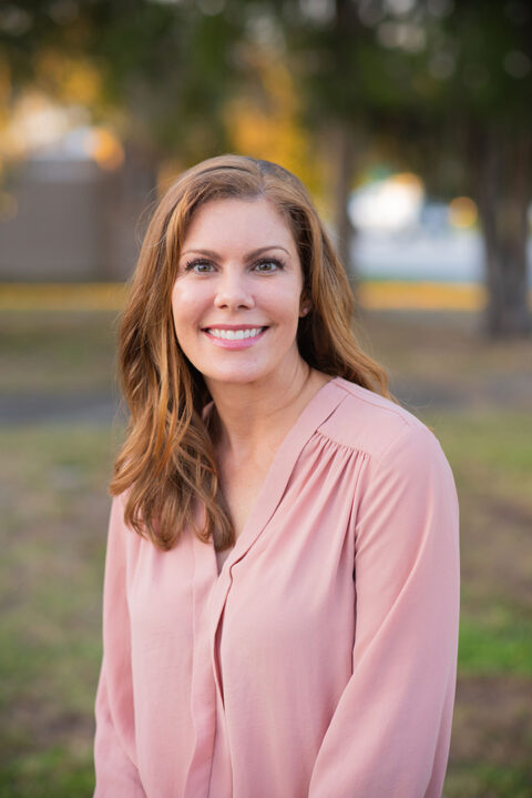 Dr. Erica Smithberger from the Clayton Dermatology Group sitting outside.