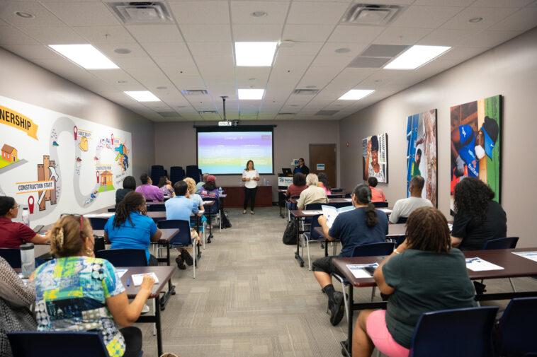 a person is lecturing a room filled with people