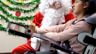 Photo of CECO student interacting with Santa at the school's annual family day event.