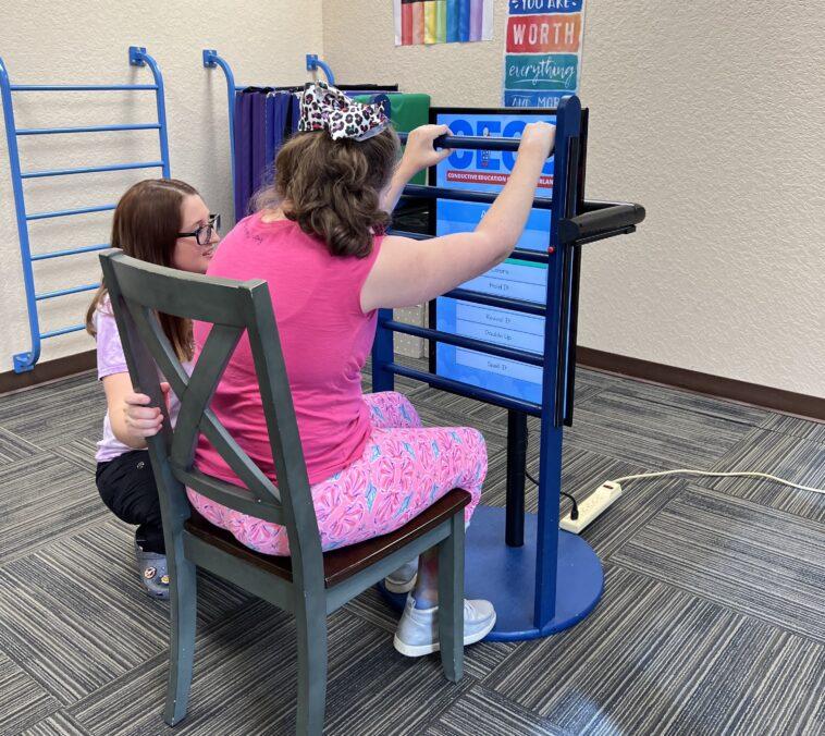 Photo of child with disabilities using the interactive ladder created by Full Sail University and CECO.