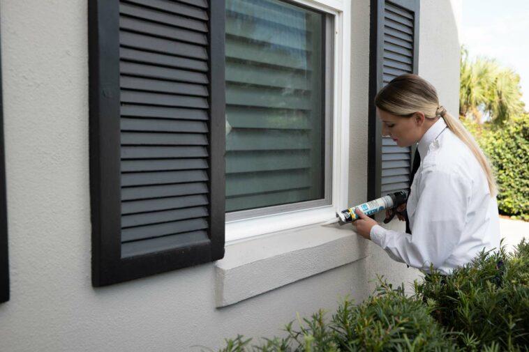 Photo of someone at Massey Services fixing up a house to prevent pests from entering.