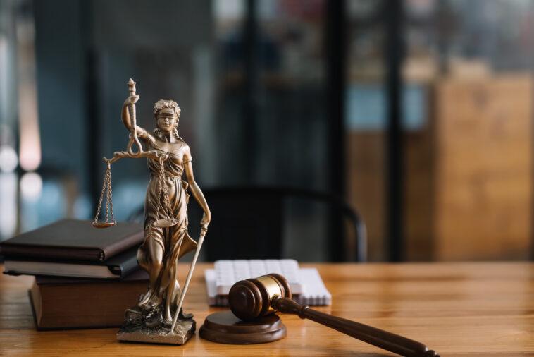 Statue of lady justice on desk of a judge or lawyer.