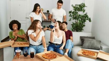group of friends eating must-have pizza while watching the Super Bowl.