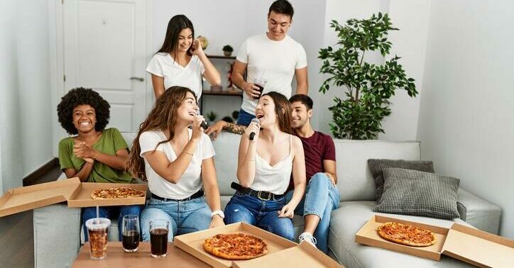 group of friends eating must-have pizza while watching the Super Bowl.