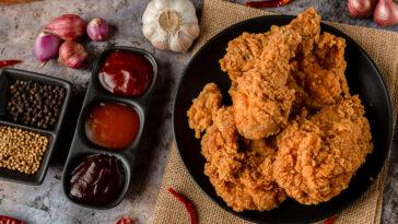crispy fried chicken plate with sides of sauces for Super Bowl foods.