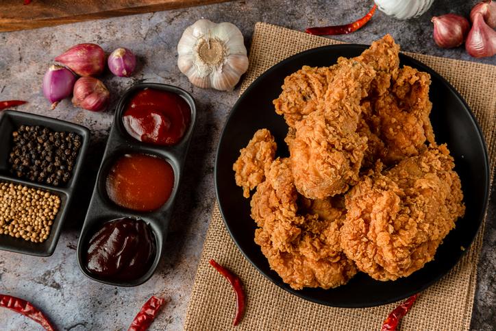 crispy fried chicken plate with sides of sauces for Super Bowl foods.