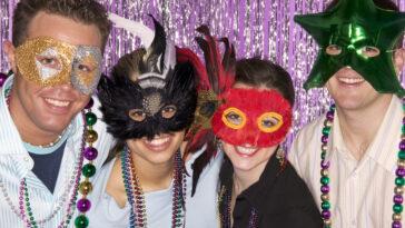 Mardi Gras Orlando. Group of friends wearing masks and beads in celebration.