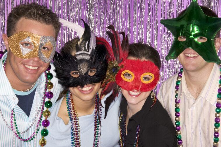 Mardi Gras Orlando. Group of friends wearing masks and beads in celebration.