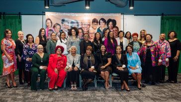 The Black women in Central Florida posing in front of the Legacy of Excellence banner.