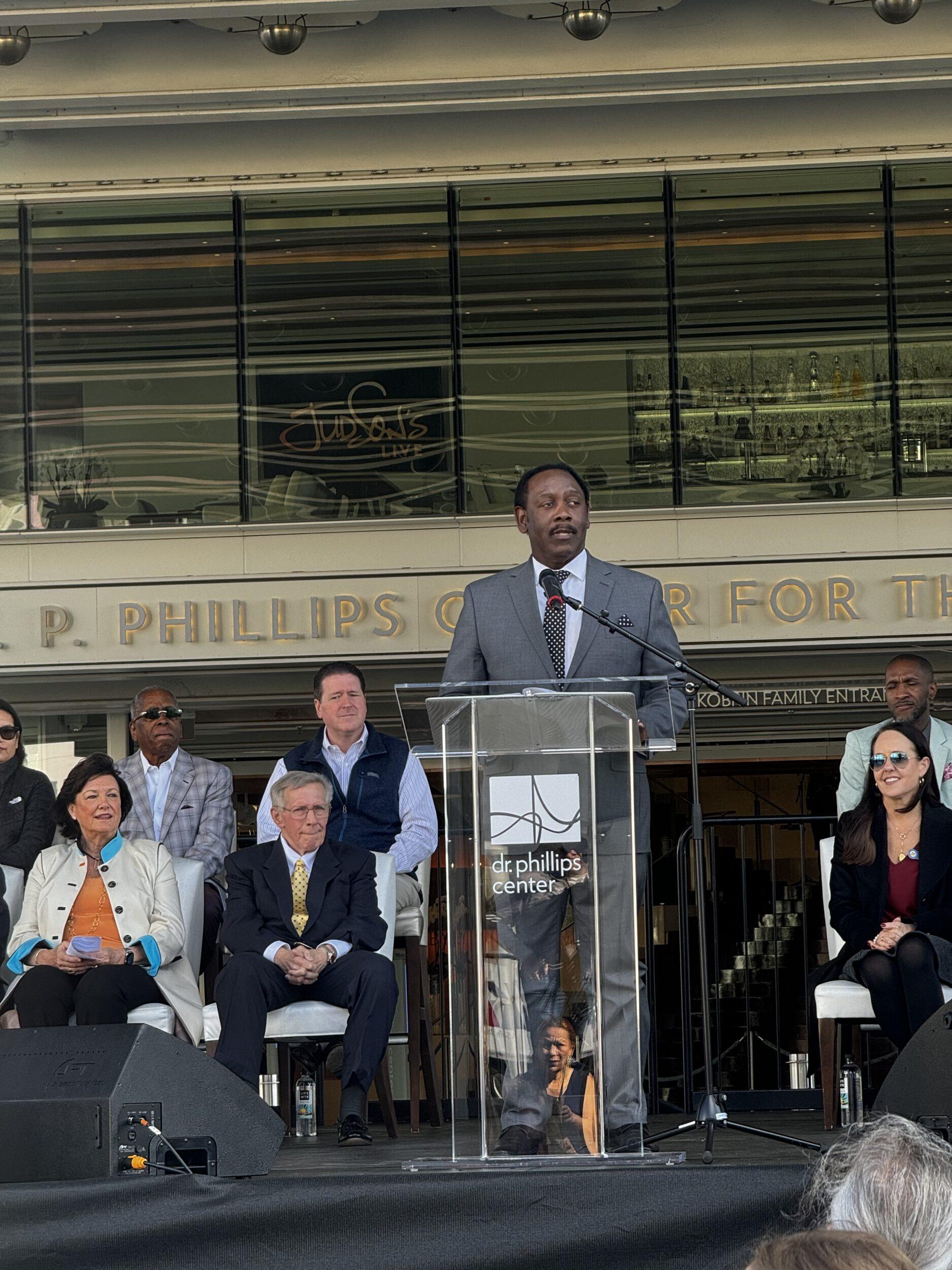 Mayor Jerry Demings speaking in front of a crowd at the Judson's Live ribbon cutting ceremony.