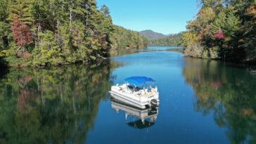 Aerial view of pontoon boat on Lake Santeetlah, North Carolina in autumn.