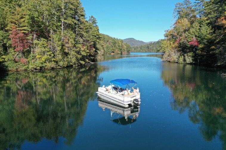 Aerial view of pontoon boat on Lake Santeetlah, North Carolina in autumn.