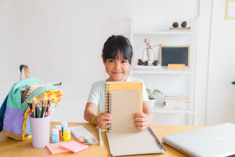 little girl with notebooks