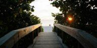 A bridge facing a beach in Naples, one of the sober-friendly travel destinations in Florida 