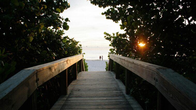 A bridge facing a beach in Naples, one of the sober-friendly travel destinations in Florida 