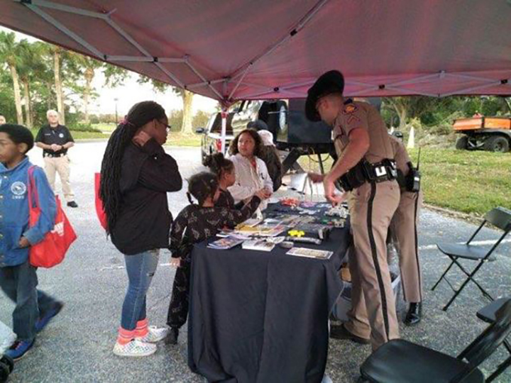 photo of community members interacting with the police at National Night Out