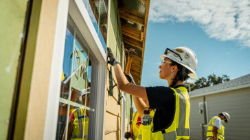 a Habitat for Humanity team working together to build a home.