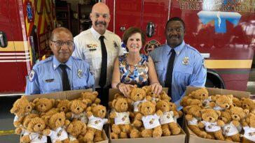 fire department behind boxes of stuffed bears