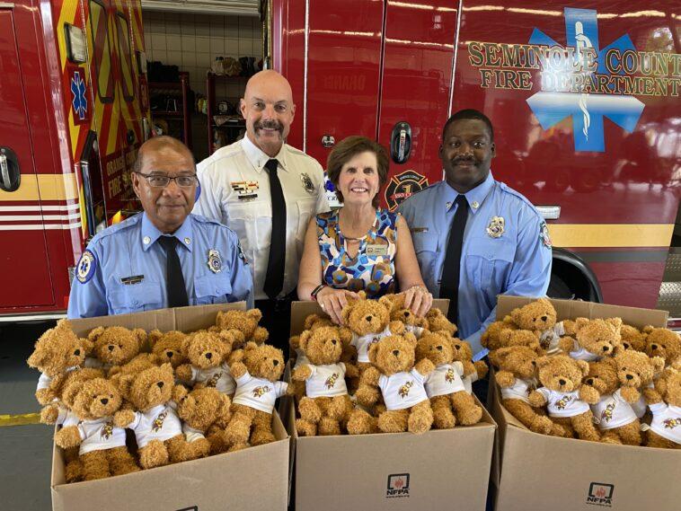 fire department behind boxes of stuffed bears